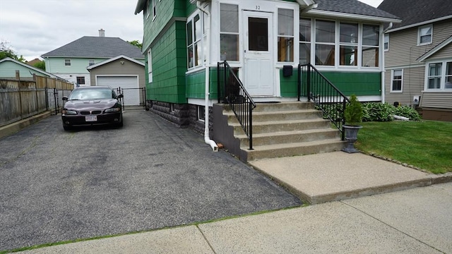 32 Bristol St, Ludlow, MA 01056 - view of front of property with driveway, a detached garage, roof with shingles, an outdoor structure, and entry steps