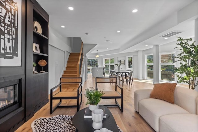 43 Stillman St Unit 201, Boston, MA 02113 - living area featuring visible vents, a fireplace, stairway, recessed lighting, and light wood-type flooring