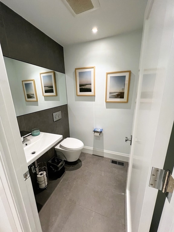 bathroom with toilet and tile patterned floors