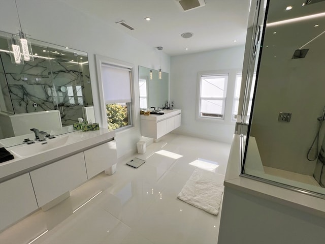 bathroom with vanity, tile patterned floors, and a shower