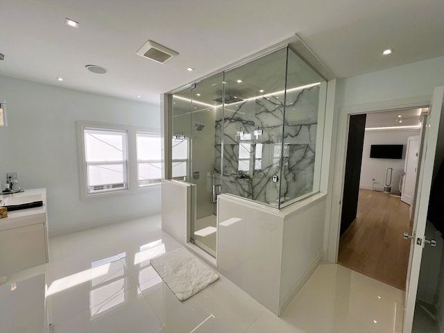 bathroom featuring an enclosed shower, vanity, and tile patterned floors