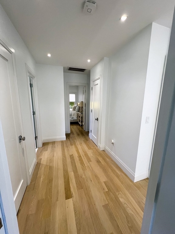 corridor with light hardwood / wood-style floors