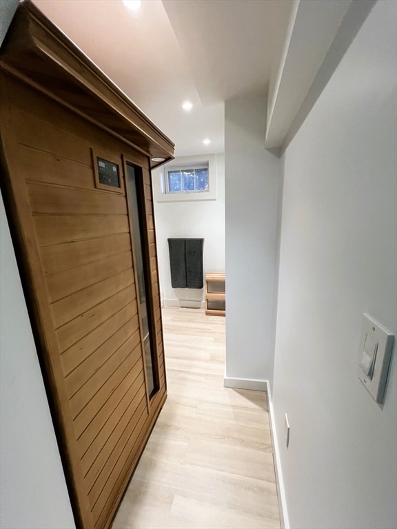 corridor with light hardwood / wood-style floors