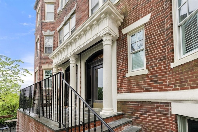 property entrance with brick siding