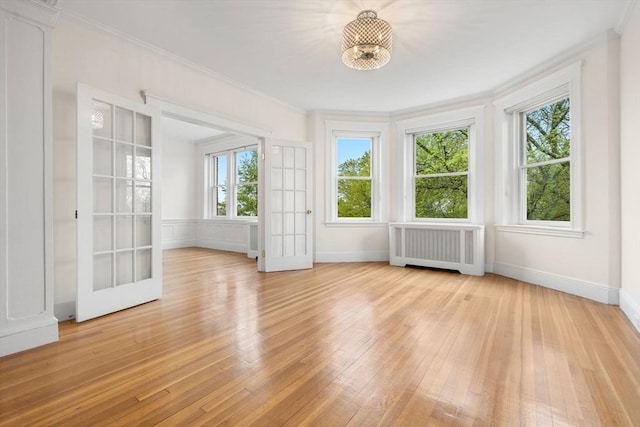 unfurnished sunroom with radiator heating unit