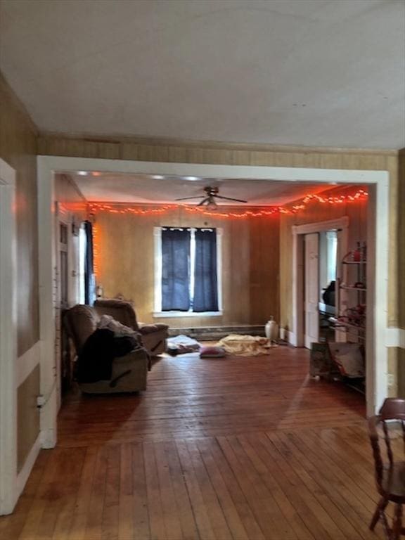 living area featuring a ceiling fan and wood finished floors