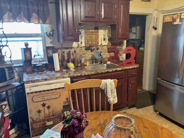 kitchen with stainless steel appliances, tasteful backsplash, and a sink