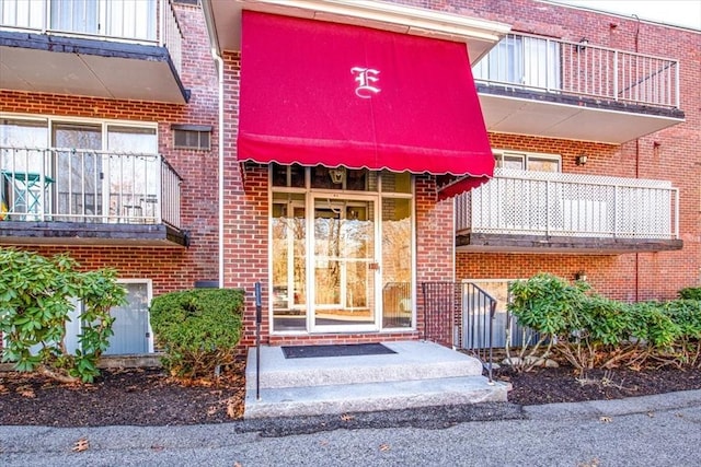 property entrance featuring brick siding