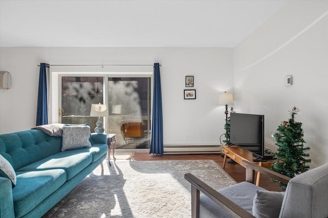 living room with a baseboard heating unit and wood finished floors