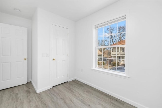38 Brook St Unit 1, Central Falls, RI 02863 - unfurnished bedroom with wood finished floors and baseboards