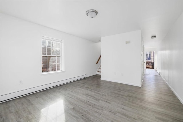38 Brook St Unit 1, Central Falls, RI 02863 - unfurnished living room featuring baseboard heating, wood finished floors, and stairway