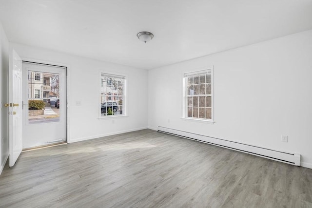 38 Brook St Unit 1, Central Falls, RI 02863 - unfurnished room featuring a baseboard radiator, plenty of natural light, and wood finished floors