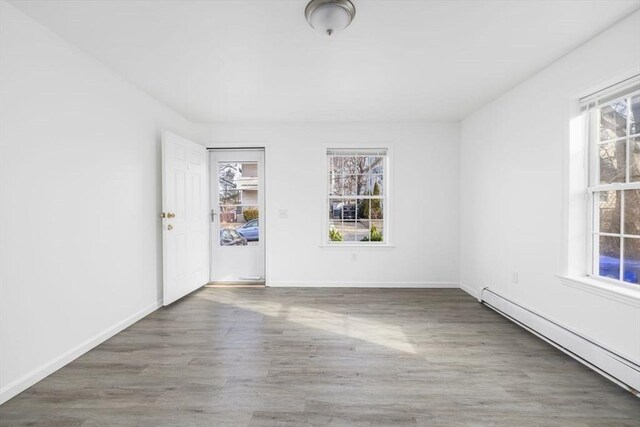38 Brook St Unit 1, Central Falls, RI 02863 - unfurnished room with baseboard heating and wood finished floors