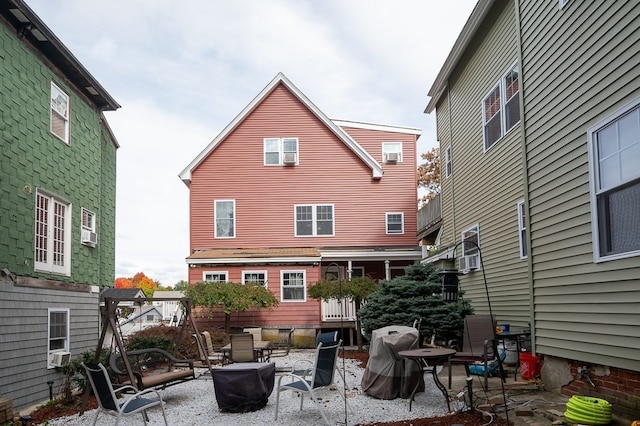 rear view of house featuring cooling unit and a patio area