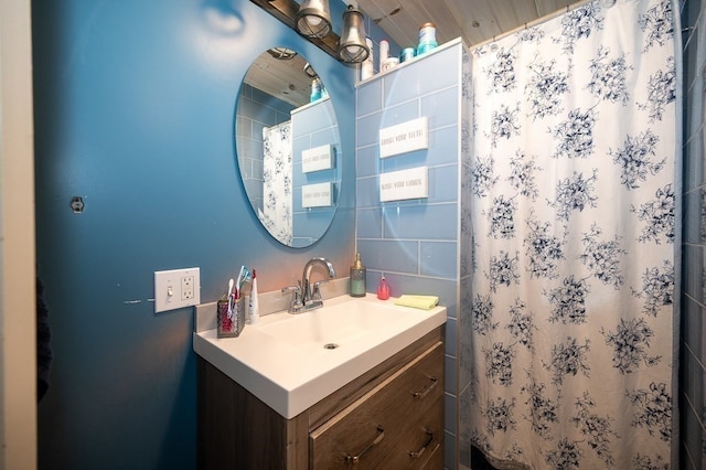 bathroom featuring vanity and curtained shower