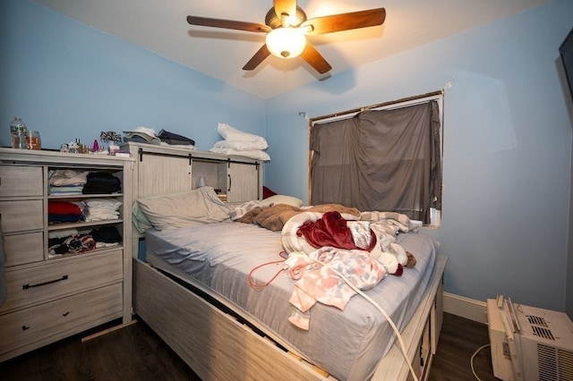 bedroom with ceiling fan and dark wood-type flooring