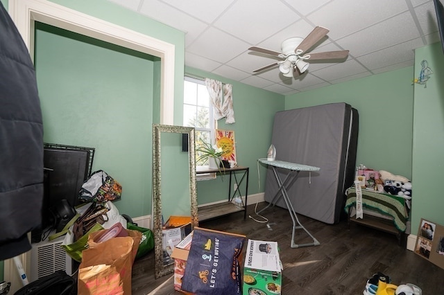 miscellaneous room with ceiling fan, a paneled ceiling, and dark wood-type flooring