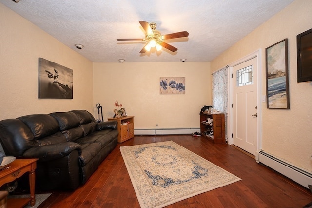 living room with a baseboard heating unit, dark hardwood / wood-style flooring, and ceiling fan