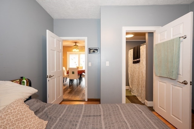 bedroom featuring hardwood / wood-style flooring and a textured ceiling