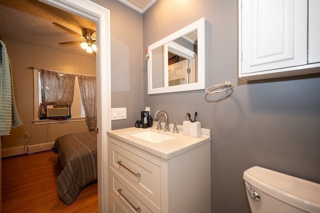 bathroom featuring ceiling fan, vanity, wood-type flooring, cooling unit, and toilet