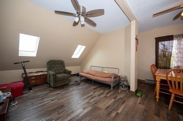 sitting room with ceiling fan, dark wood-type flooring, and lofted ceiling with skylight