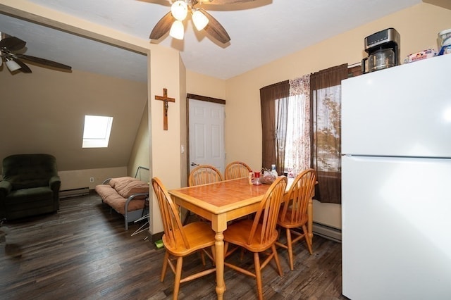 dining room with ceiling fan, plenty of natural light, vaulted ceiling with skylight, and dark hardwood / wood-style flooring