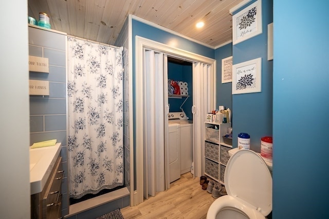 bathroom featuring vanity, hardwood / wood-style flooring, wooden ceiling, washing machine and dryer, and toilet