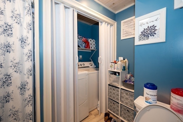 bathroom with hardwood / wood-style flooring, crown molding, toilet, and washing machine and dryer