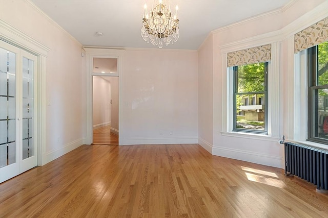 114 Fenway Unit 2, Boston, MA 02115 - unfurnished room with radiator, a chandelier, baseboards, light wood-style flooring, and crown molding