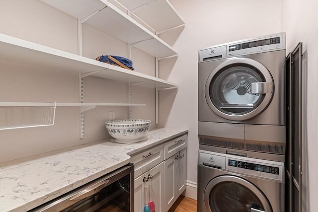 114 Fenway Unit 2, Boston, MA 02115 - clothes washing area featuring stacked washer / dryer, beverage cooler, cabinet space, and light wood-style floors