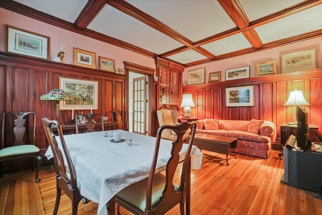 dining area with coffered ceiling, light wood-type flooring, beam ceiling, and french doors