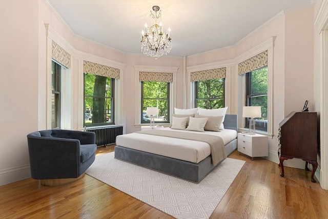 114 Fenway Unit 2, Boston, MA 02115 - bedroom with radiator, a chandelier, wood finished floors, crown molding, and baseboards