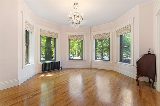 114 Fenway Unit 2, Boston, MA 02115 - unfurnished room featuring radiator heating unit, a chandelier, wood finished floors, baseboards, and ornamental molding
