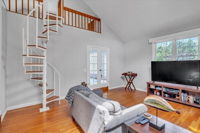 57 Center St, Dartmouth, MA 02748 - living room featuring stairs, french doors, wood finished floors, high vaulted ceiling, and baseboards