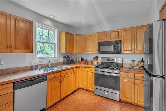 57 Center St, Dartmouth, MA 02748 - kitchen with appliances with stainless steel finishes, a sink, and light countertops