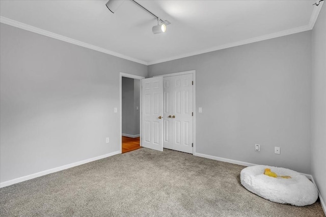 57 Center St, Dartmouth, MA 02748 - unfurnished bedroom featuring carpet, rail lighting, crown molding, and baseboards