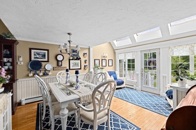 39 High Beacon Way, Marshfield, MA 02050 - dining room featuring a textured ceiling, a baseboard heating unit, hardwood / wood-style flooring, a skylight, and a chandelier