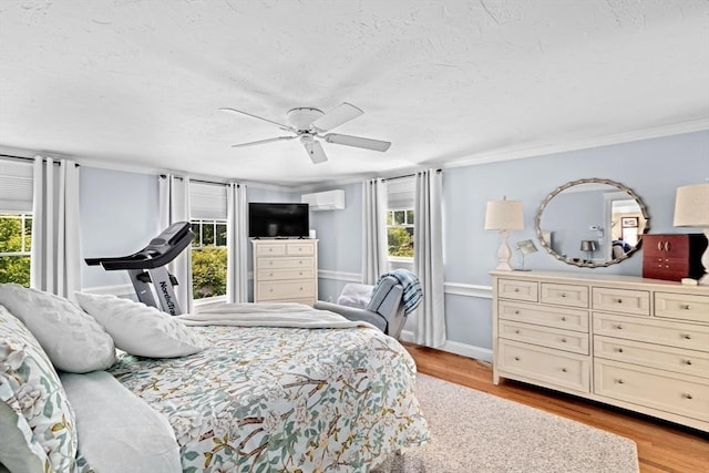 39 High Beacon Way, Marshfield, MA 02050 - bedroom featuring light wood-style floors, an AC wall unit, a textured ceiling, ornamental molding, and a ceiling fan