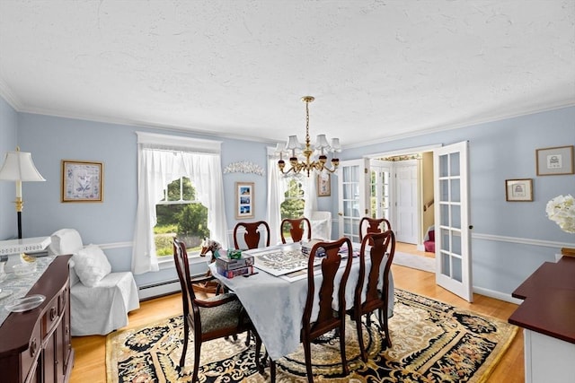39 High Beacon Way, Marshfield, MA 02050 - dining space with a chandelier, ornamental molding, french doors, a textured ceiling, and light wood-type flooring