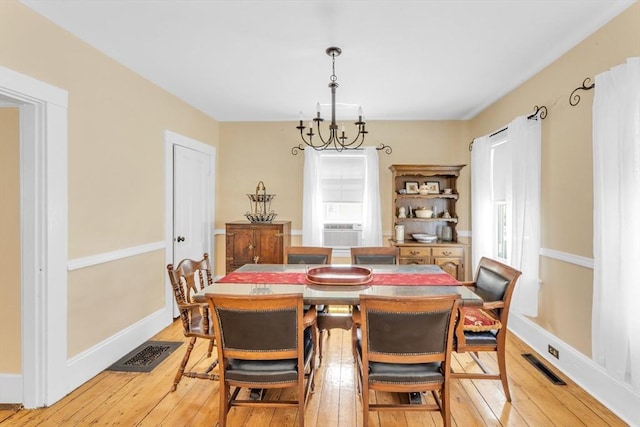 252 Railroad Ave, Norwood, MA 02062 - dining space with light wood finished floors, a chandelier, and cooling unit