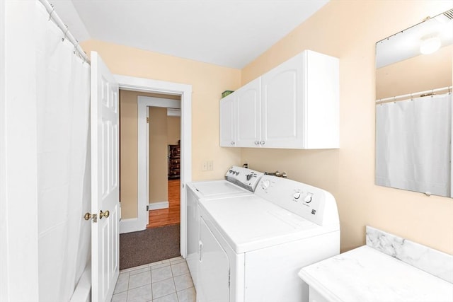 252 Railroad Ave, Norwood, MA 02062 - washroom featuring cabinet space, washer and clothes dryer, light tile patterned floors, and light colored carpet