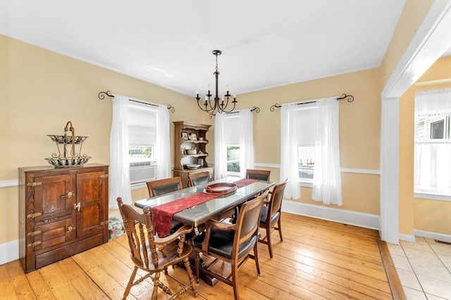 252 Railroad Ave, Norwood, MA 02062 - dining area featuring healthy amount of natural light, a chandelier, light wood-type flooring, and cooling unit