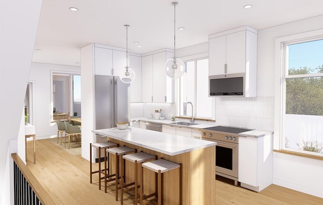 kitchen with backsplash, stainless steel electric range oven, light countertops, and a sink