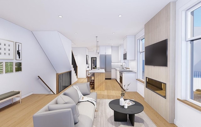 living area with recessed lighting and light wood-style floors