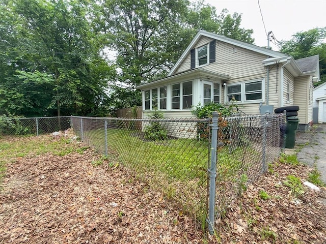 23 Eldert St, Springfield, MA 01109 - view of front of property with a sunroom and a fenced backyard