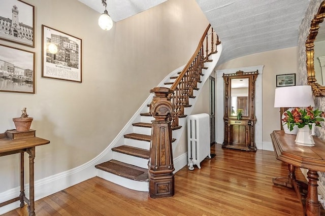 2 Oxford Pl, Worcester, MA 01609 - stairway featuring radiator, baseboards, and wood-type flooring