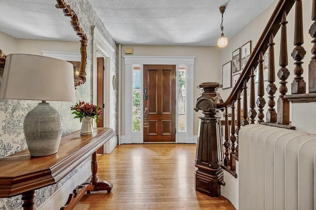 2 Oxford Pl, Worcester, MA 01609 - entrance foyer featuring light wood-style floors, stairway, and a textured ceiling