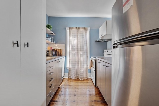 2 Oxford Pl, Worcester, MA 01609 - kitchen with freestanding refrigerator, double oven range, under cabinet range hood, light countertops, and white cabinets