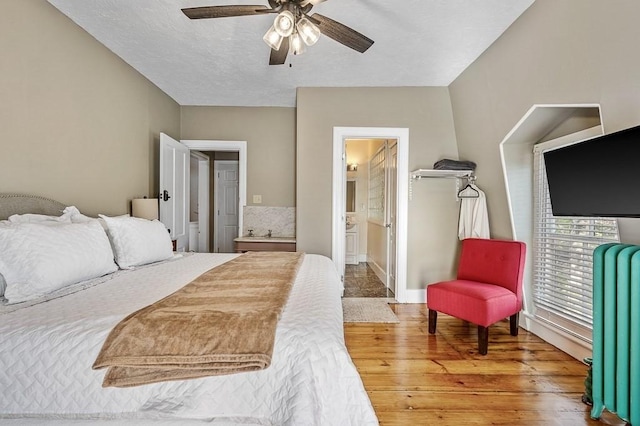 2 Oxford Pl, Worcester, MA 01609 - bedroom with radiator, wood finished floors, baseboards, a ceiling fan, and ensuite bath