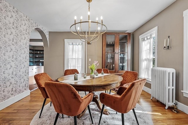 2 Oxford Pl, Worcester, MA 01609 - dining room featuring radiator, wallpapered walls, light wood finished floors, a chandelier, and baseboards